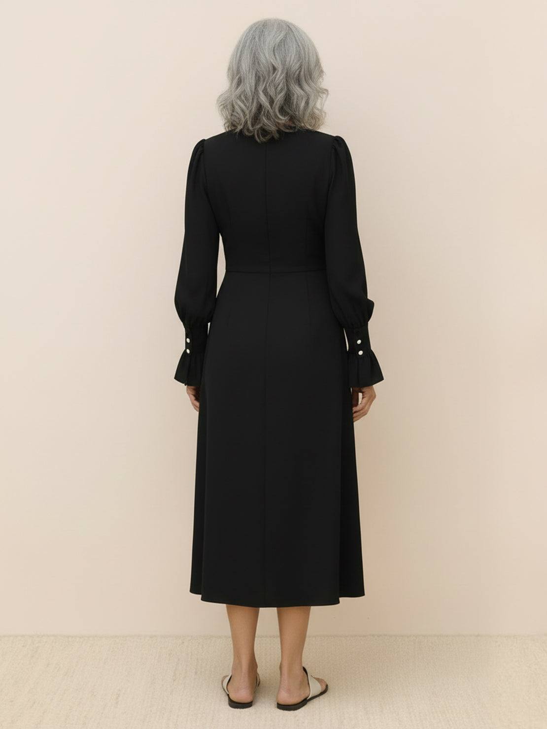 Slimming V-neck midi dress with fitted bodice, button-front detail, long sleeves, and A-line skirt.
