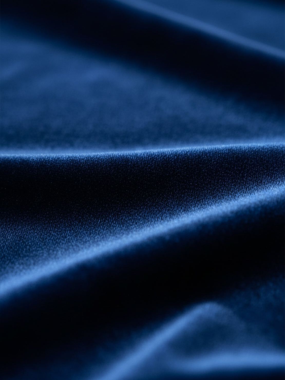 Woman wearing deep V-neck velvet suit with long sleeves, removable waist tie, and wide-leg pants at formal event