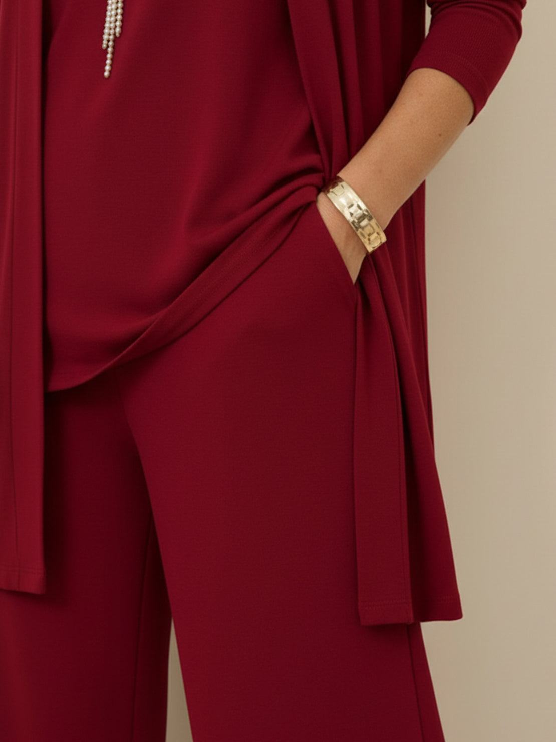 Woman wearing open-front three-piece co-ord with longline cardigan, round-neck tank, and wide-leg trousers