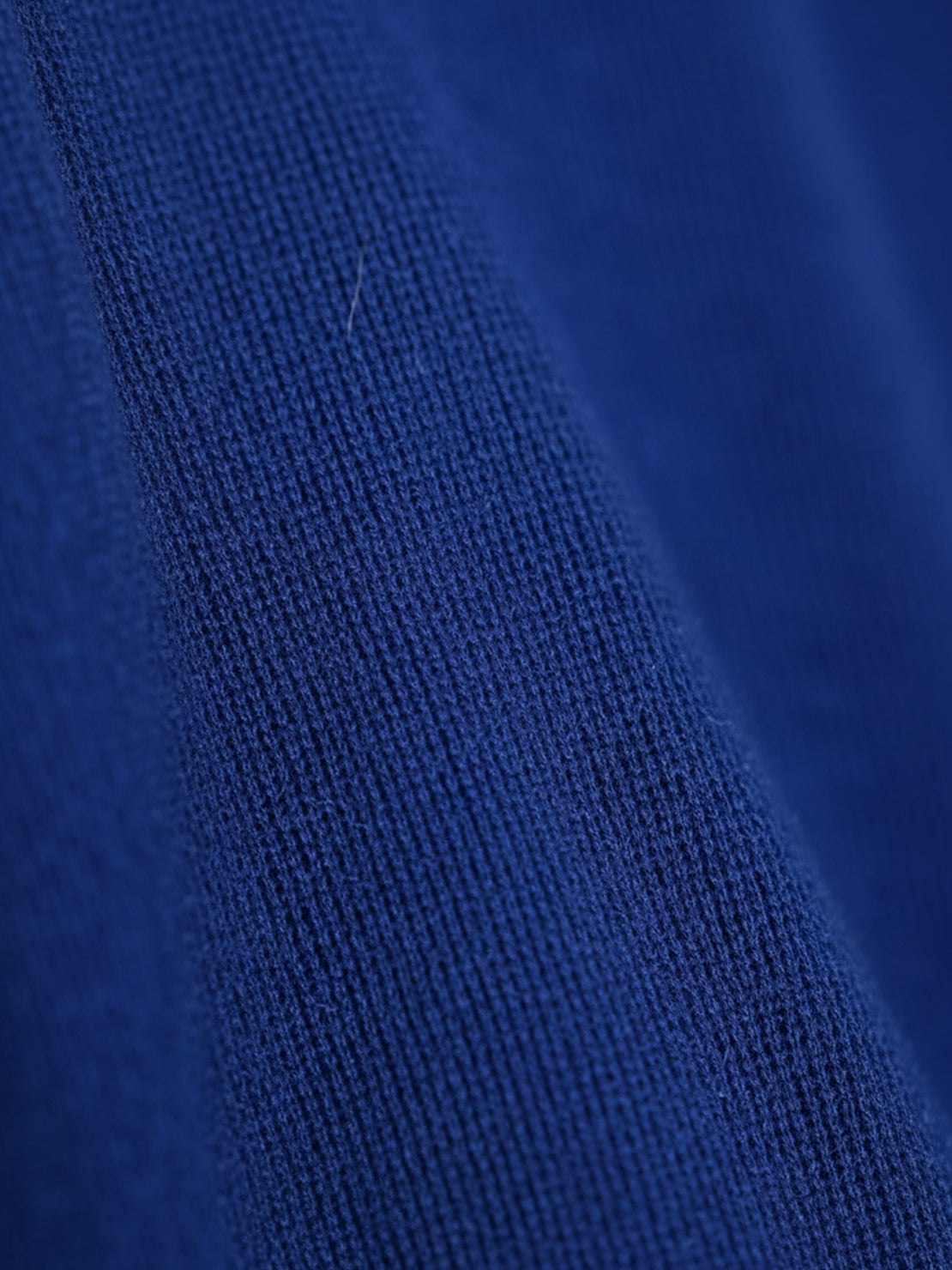 Woman wearing open-front three-piece co-ord with longline cardigan, tank top, and wide-leg trousers