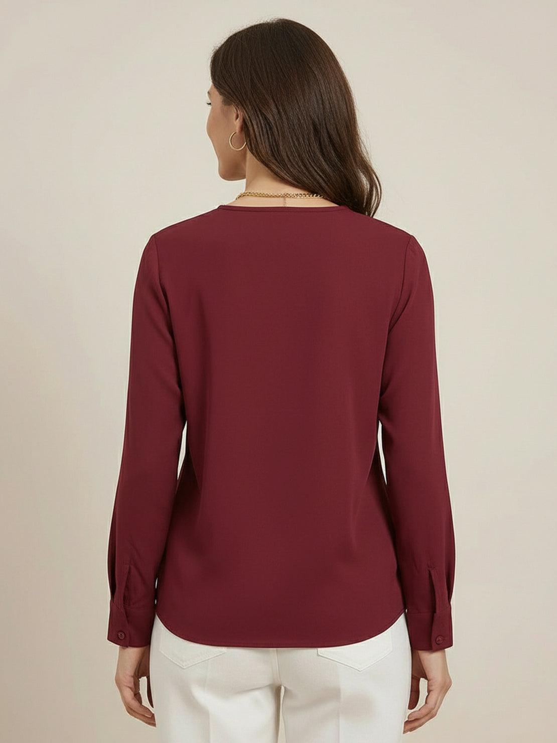 White pleated V-neck long-sleeve blouse with relaxed fit and button cuffs