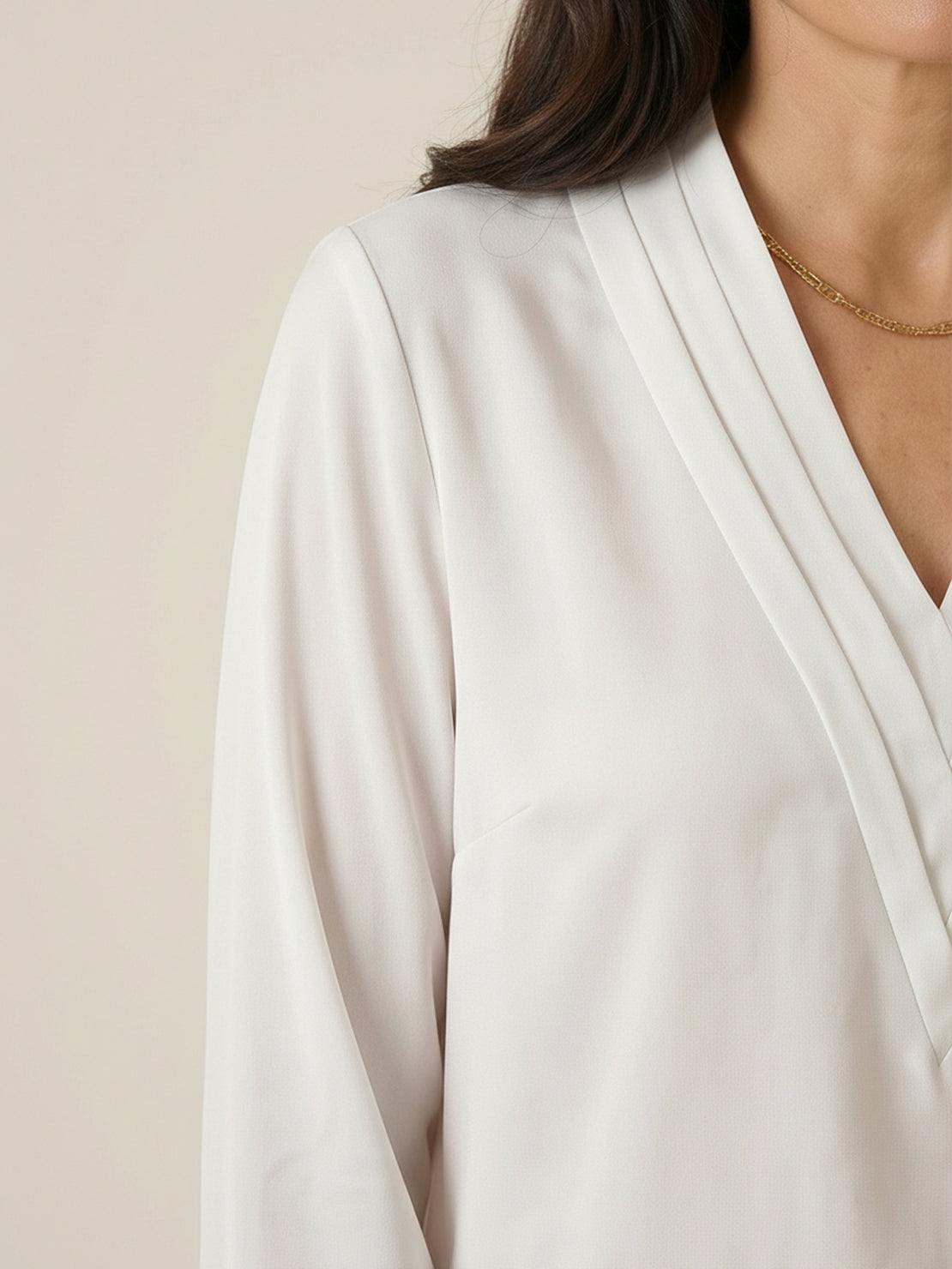 Pleated V-neck long-sleeve blouse with relaxed fit and button cuffs
