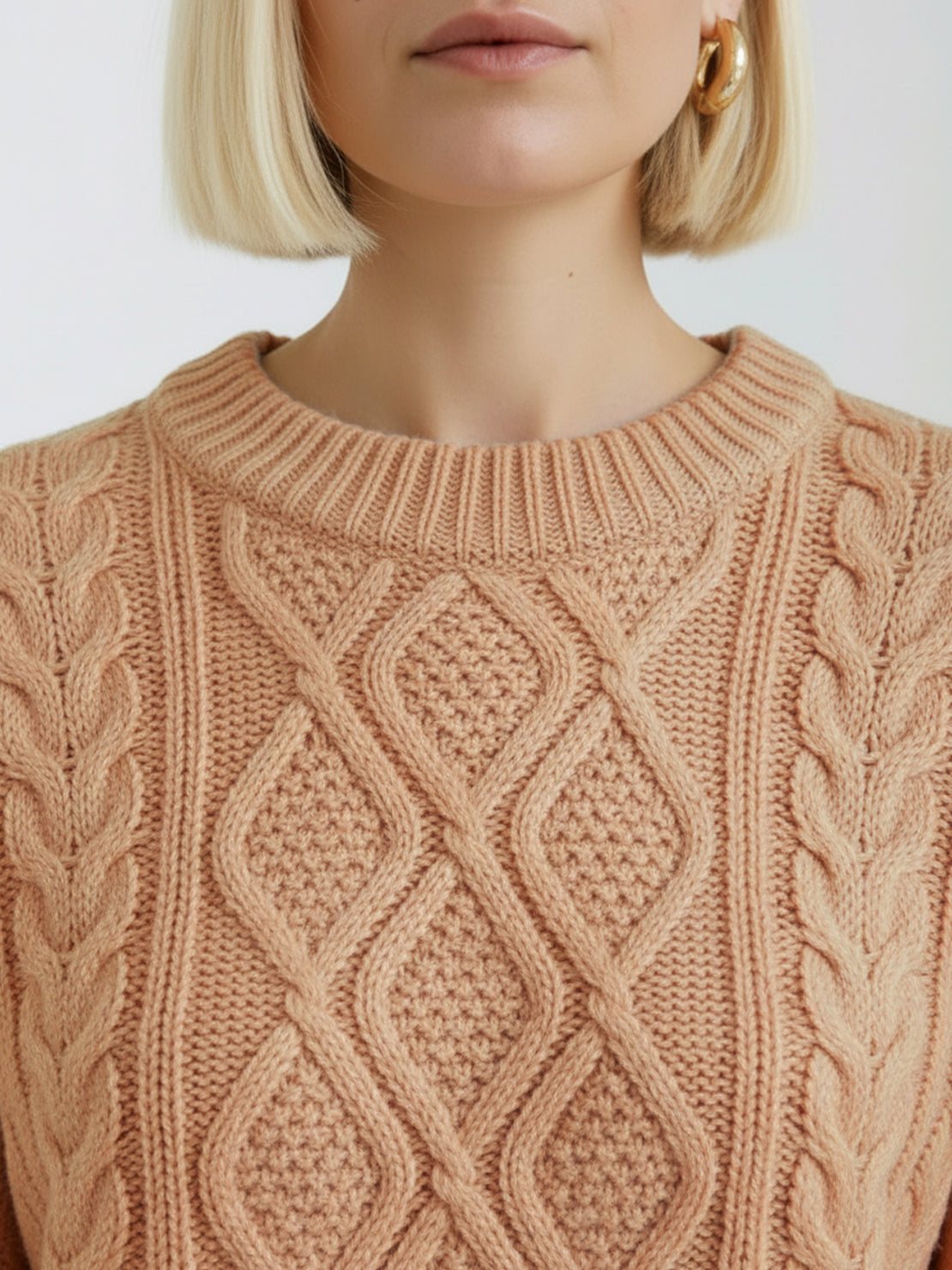 Oversized cable-knit crewneck sweater with dropped shoulders and ribbed cuffs