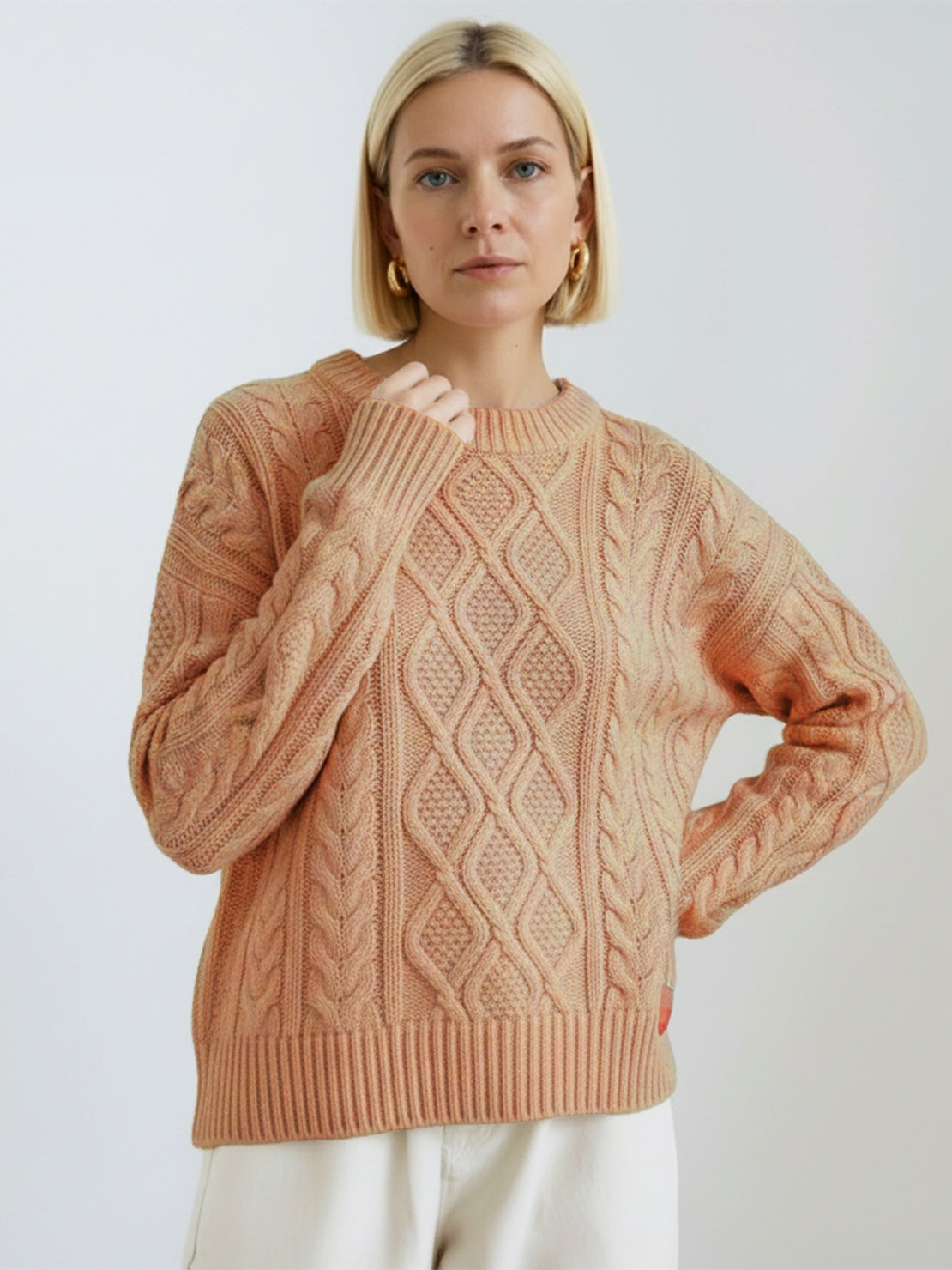 Oversized cable-knit crewneck sweater with dropped shoulders and ribbed trim