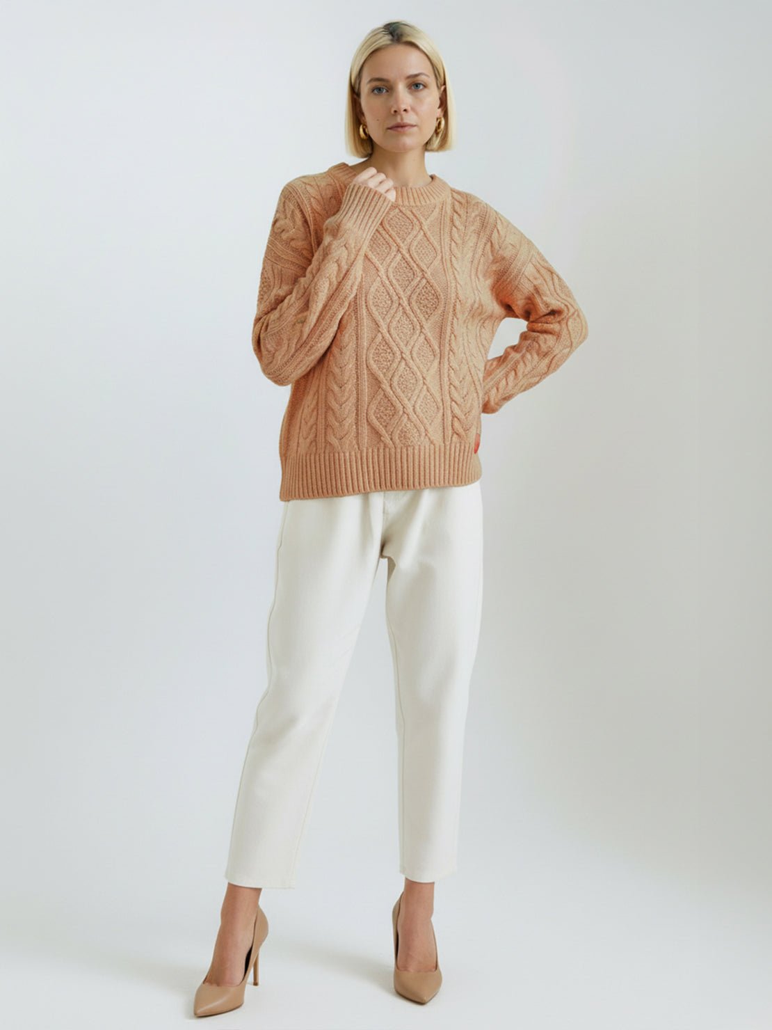 Oversized cable-knit crewneck sweater with dropped shoulders and ribbed trim