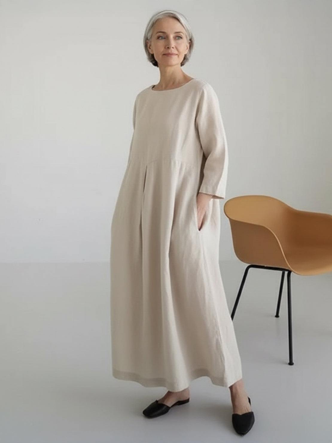 Cotton-linen empire waist dress with natural crinkle texture, 3/4 sleeves, and deep pockets.