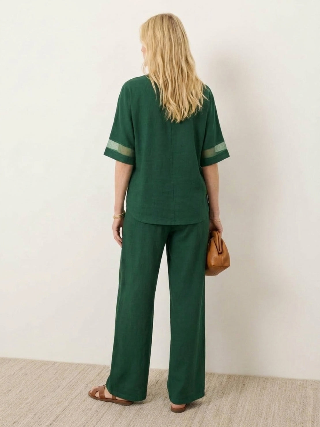 Lightweight linen top with V-neck and three-button detail on mature woman