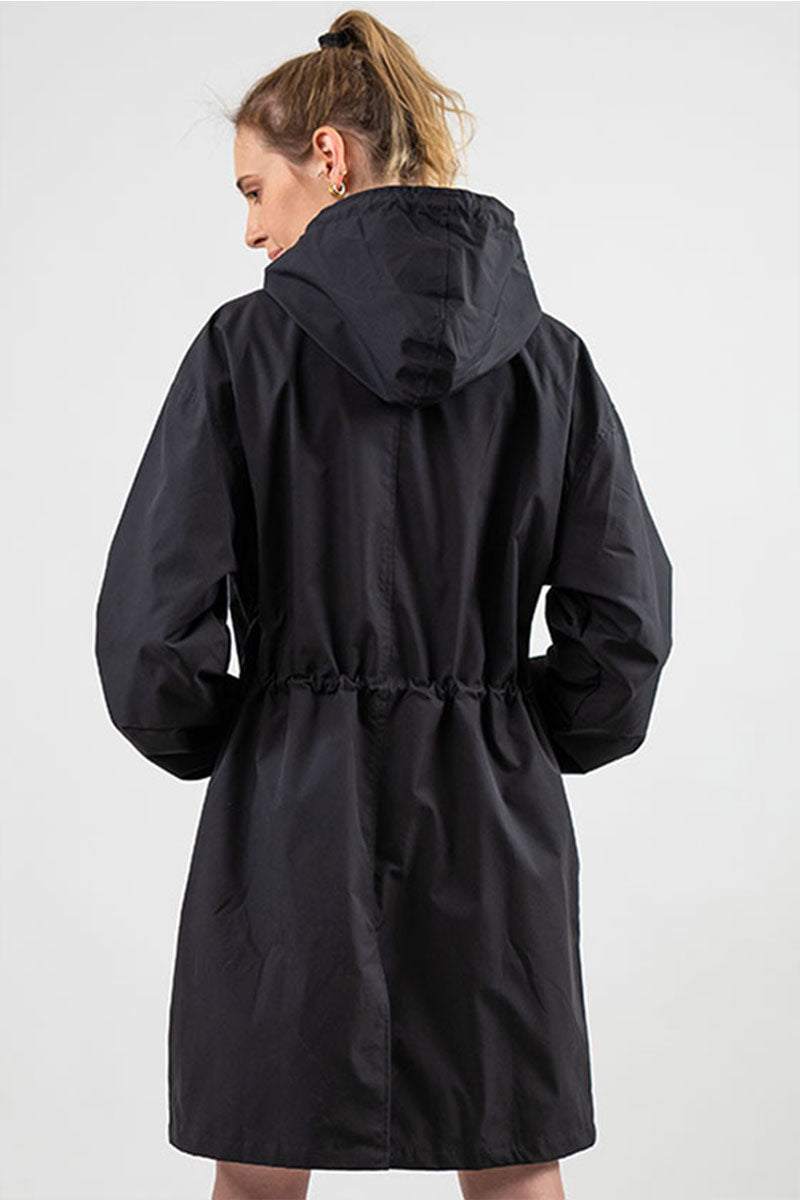 Black oversized water-resistant windbreaker jacket with hood worn by woman, back view
