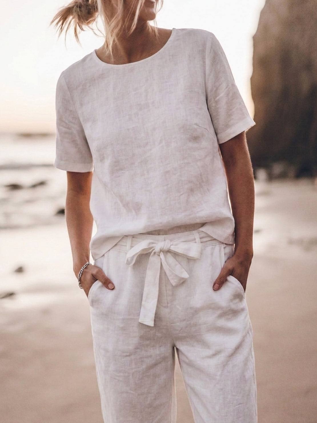 Woman wearing relaxed cotton linen set with short-sleeve top and straight-leg pants in monochrome tones