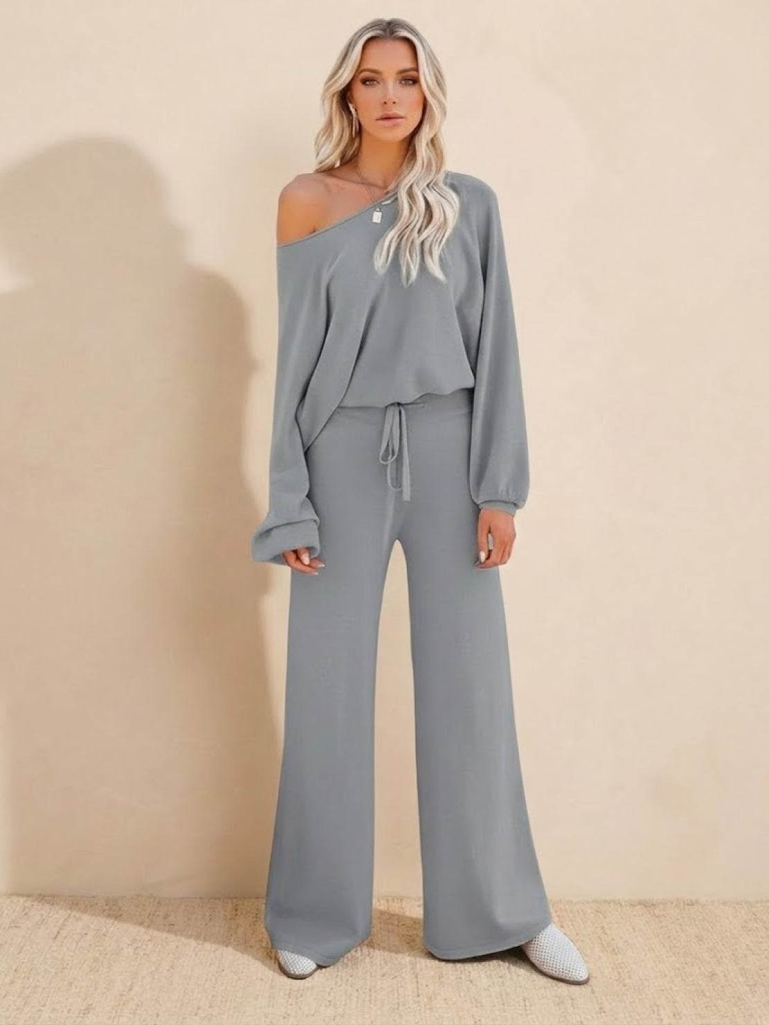 Woman wearing gray round neck loose fit cozy two-piece set with wide-leg pants and long sleeves