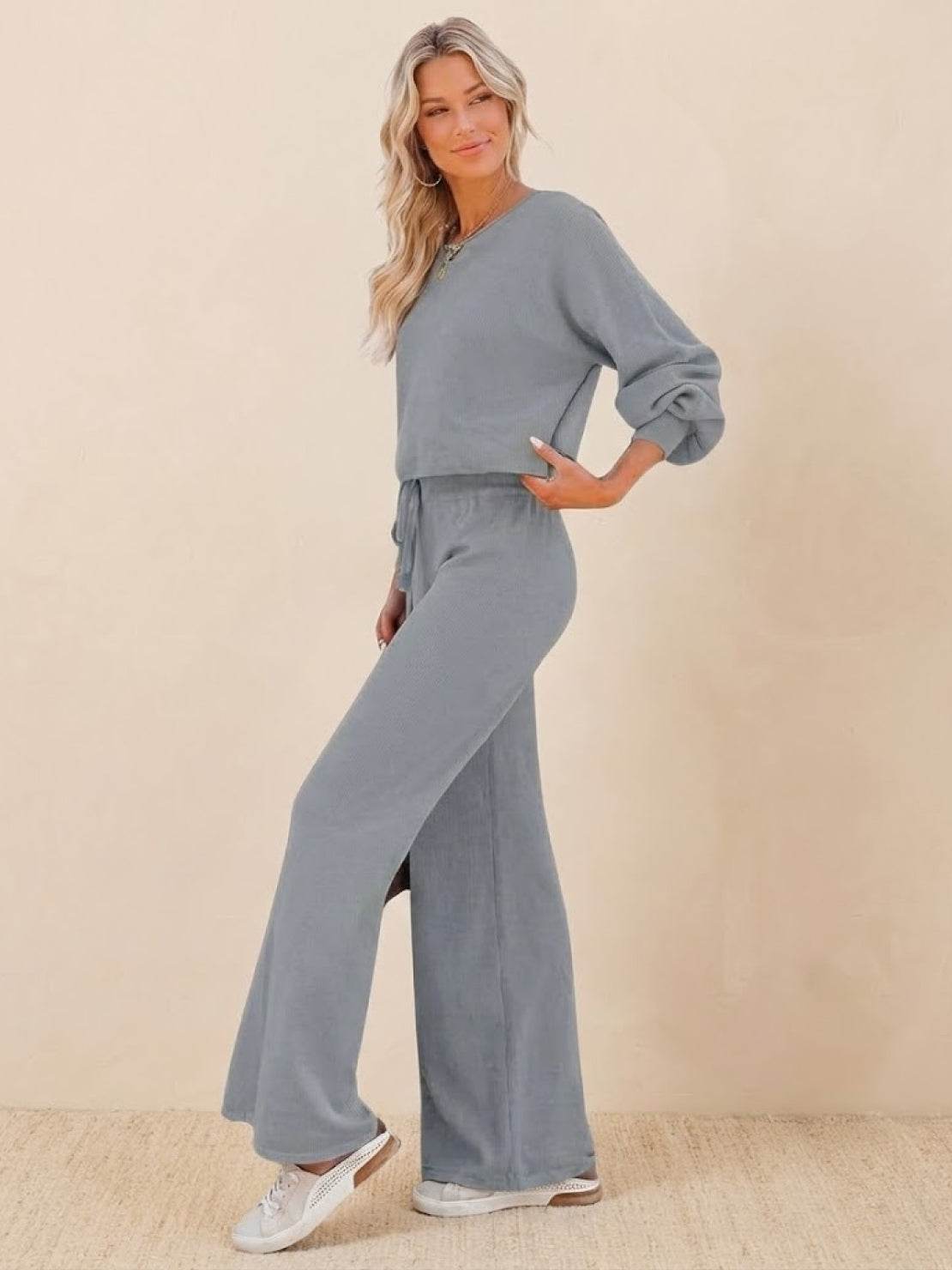 Woman wearing a gray round neck loose fit cozy two-piece set with wide-leg pants and long sleeves
