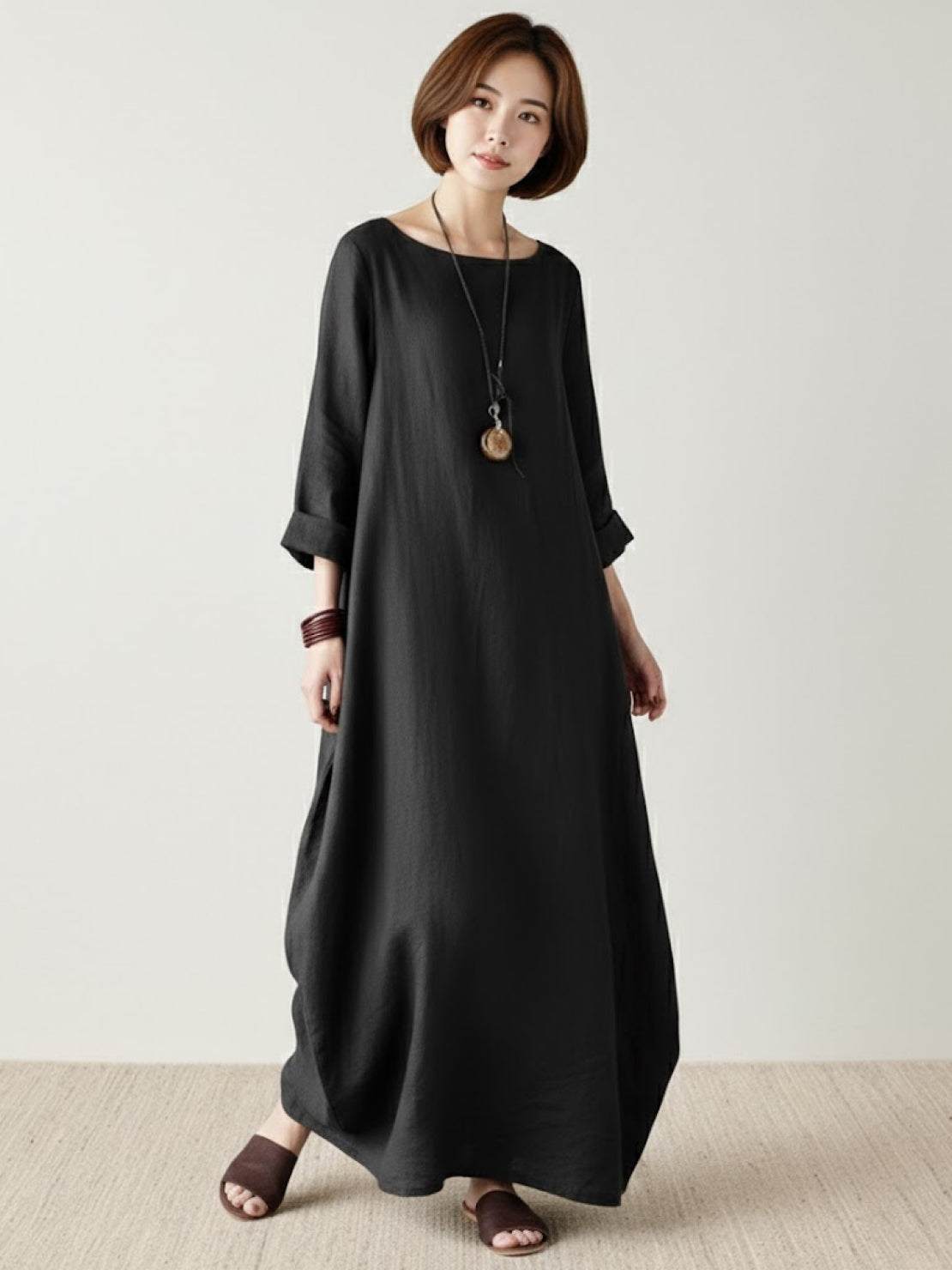 Loose fit bohemian maxi dress in breathable linen blend with long sleeves and floor-length hem.