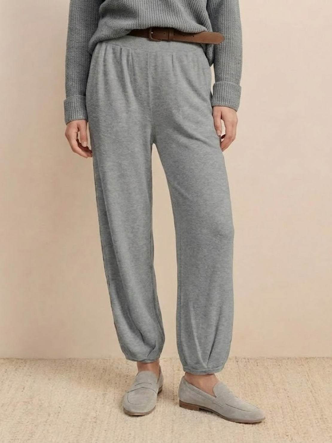 Gray relaxed knit trousers styled for European minimalism fashion