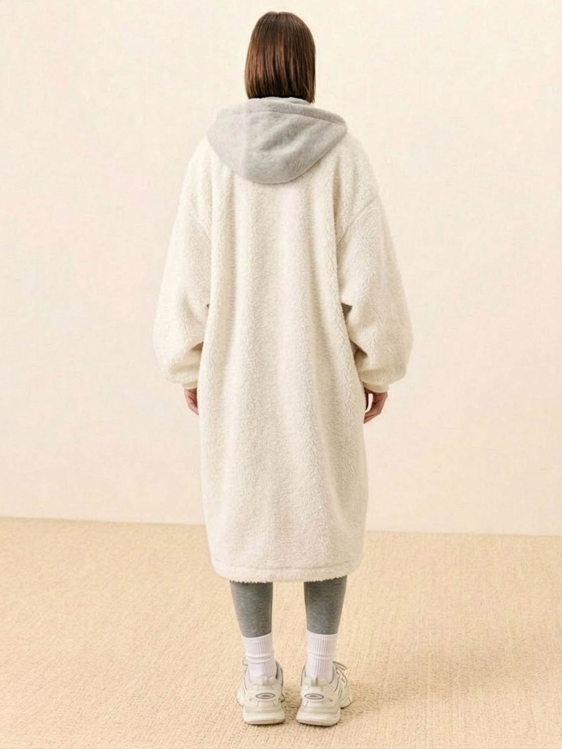 Back view of a person wearing an everyday wear oversized sherpa long coat with a hood, showcasing the cozy and plush texture.