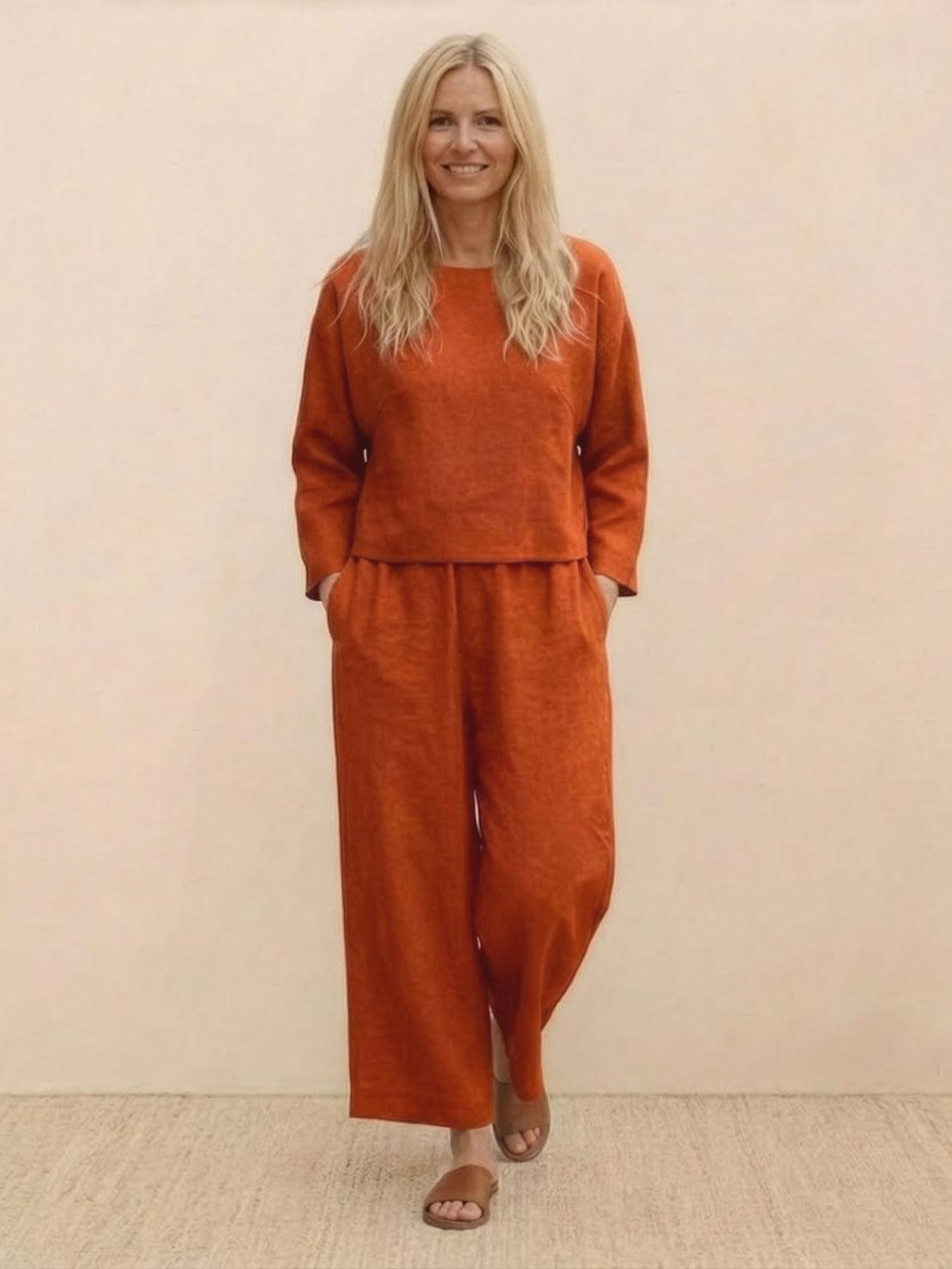 Woman wearing loose solid color two-piece set with wide-leg pants and round-neck top