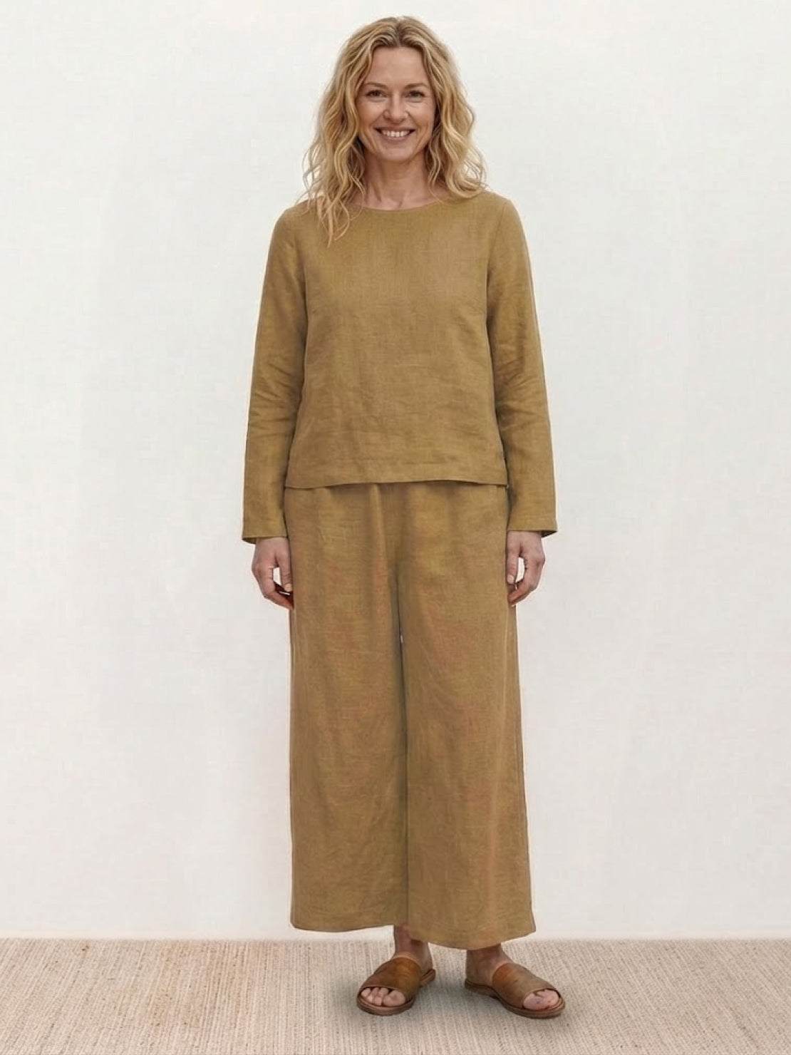 Woman wearing loose solid color two-piece set with round-neck top and wide-leg pants