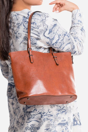 Brown PU leather multi strap tote shopper bag worn on shoulder with buckle details and spacious interior