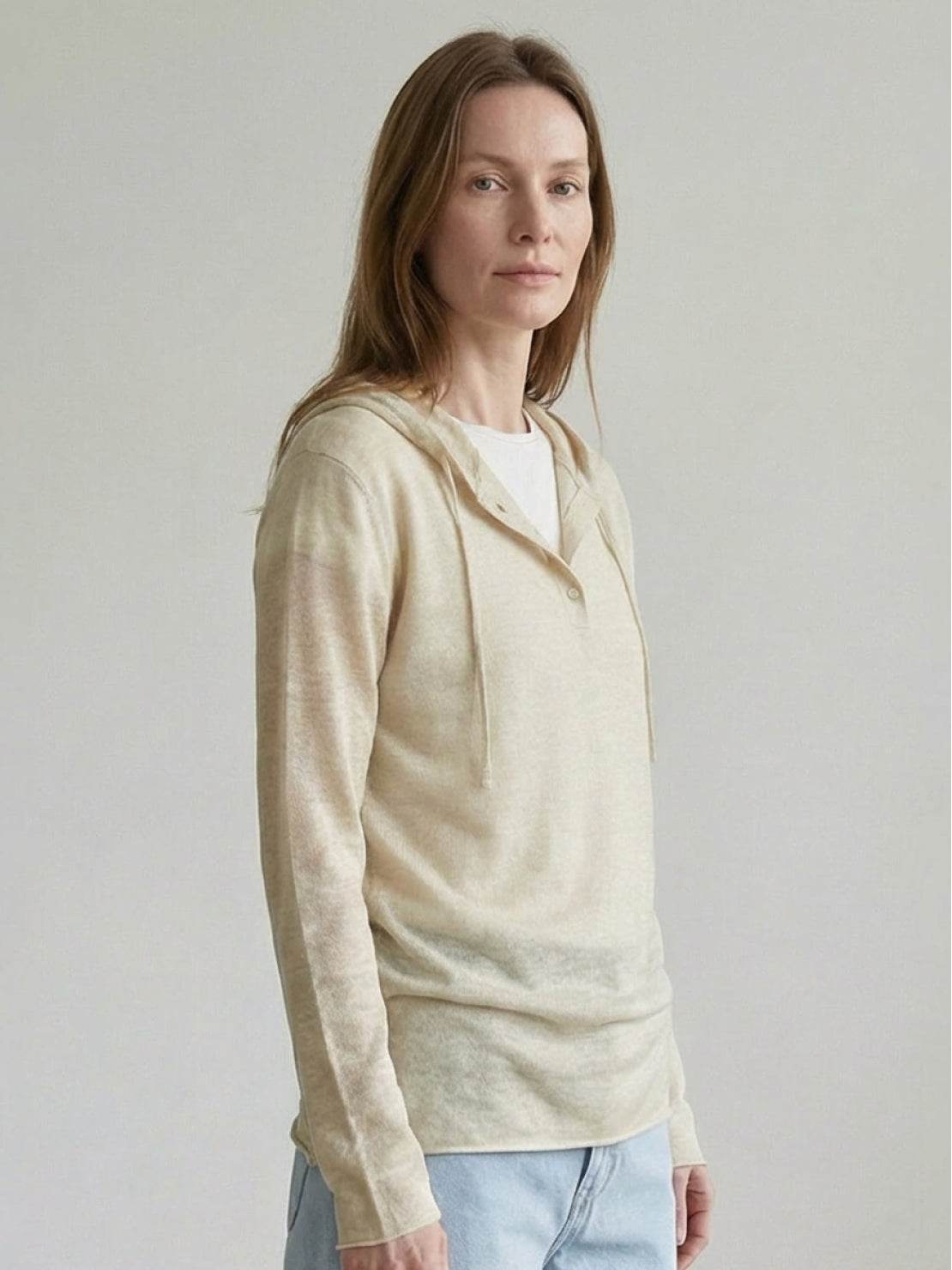 Organic linen henley top with fine knit, relaxed fit, long sleeves, and side slits in neutral heathered fabric