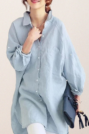 Light blue oversized linen shirt with button-down front and loose sleeves worn casually by woman