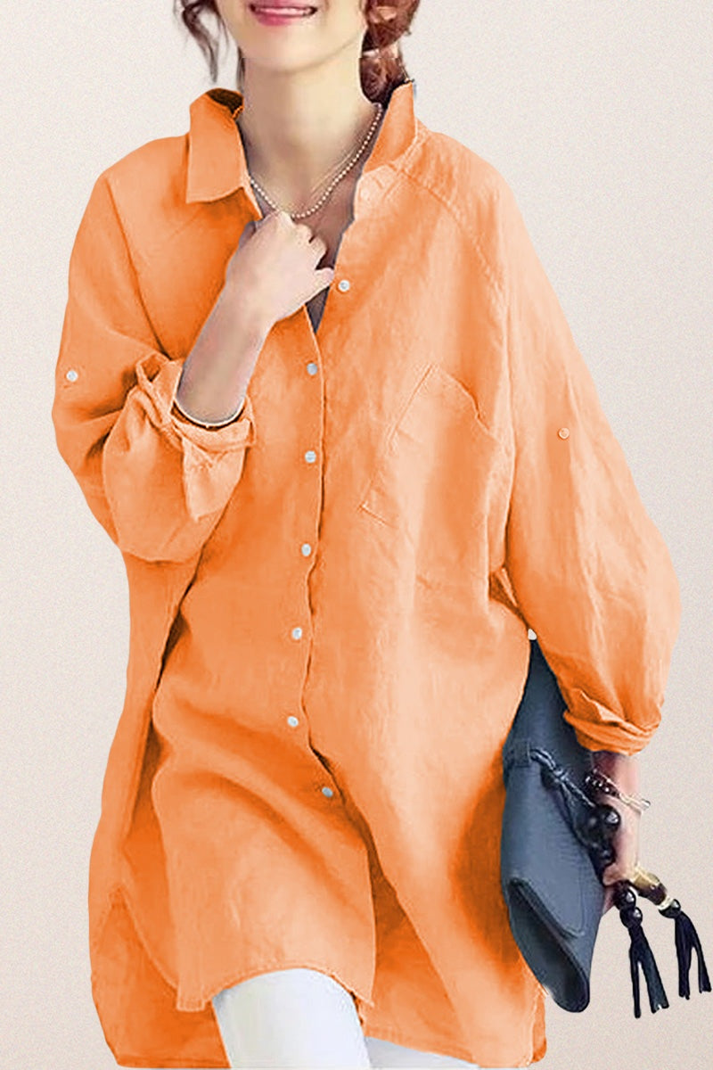 Oversized linen shirt in soft orange with relaxed fit and button front, styled casually with accessories.