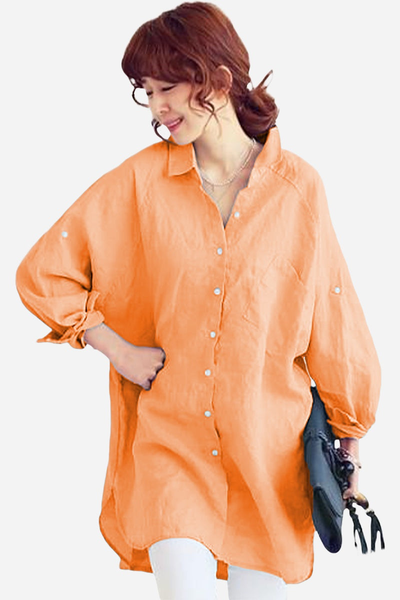 Woman wearing oversized linen shirt in sun-washed pink with relaxed fit and button detailing