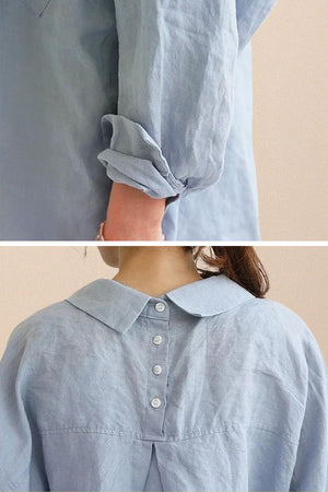 Light blue oversized linen shirt with rolled-up sleeves and buttoned back detailing