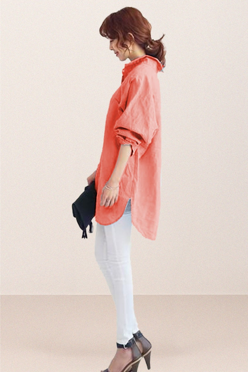 Woman wearing oversized linen shirt in sun-washed pink with rolled sleeves and white pants