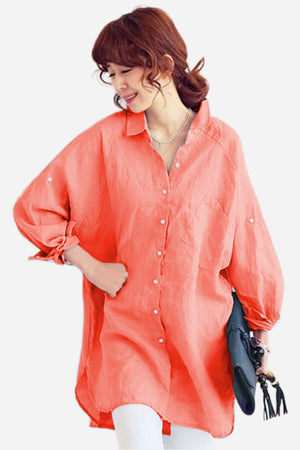 Woman wearing oversized linen shirt in sun-washed pink with loose sleeves and button details