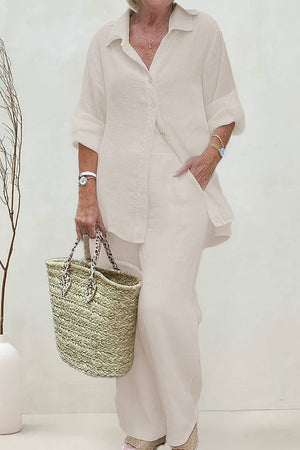 woman wearing oversized 100 cotton shirt and wide-leg pants co-ord set with woven tote bag