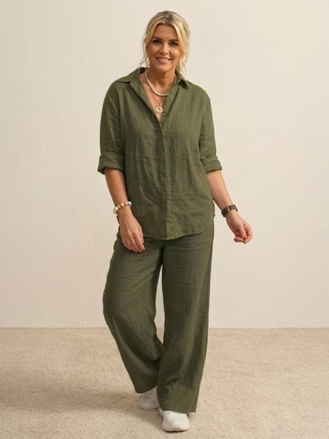 Woman wearing oversized 100% cotton olive green shirt and wide-leg pants co-ord set with rolled sleeves and relaxed fit