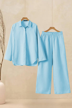 Oversized 100% cotton light blue shirt and wide-leg pants co-ord set hanging on wooden hangers