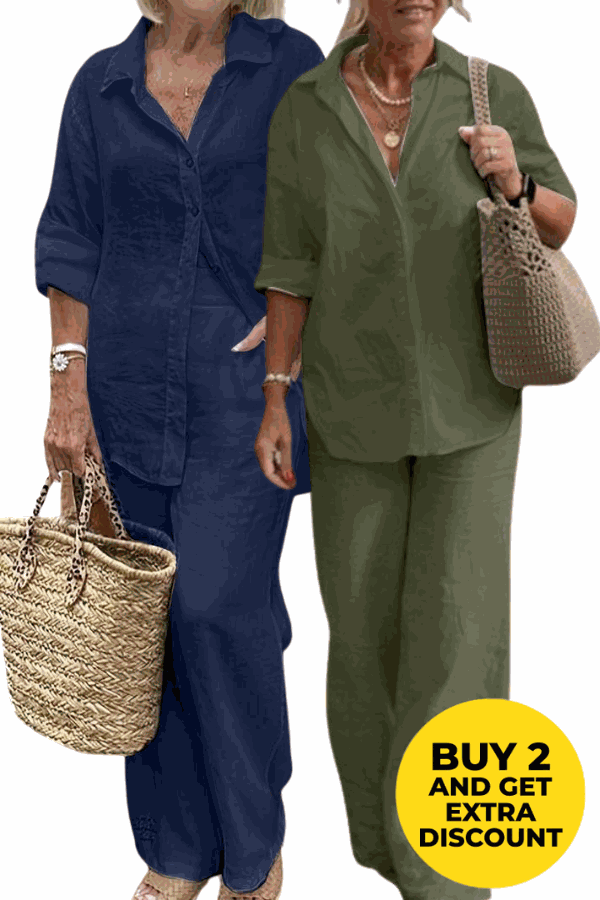 Two women wearing relaxed shirt and trousers two-piece sets in navy blue and olive green, carrying woven handbags, showcasing casual comfort and style.