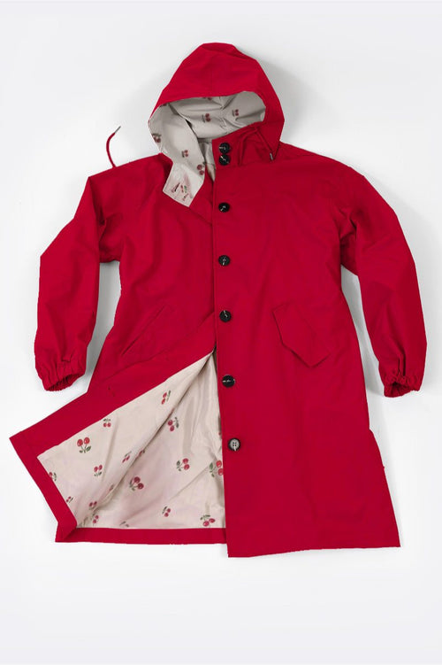 Red oversized Rain Couture Windbreaker with hood and floral patterned interior lining.