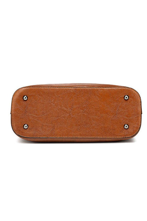 Bottom view of brown multi strap tote shopper bag with metal feet on PU leather base