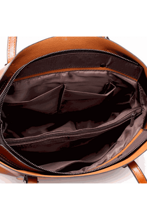 Interior view of a multi strap tote bag showing multiple compartments and brown lining fabric.