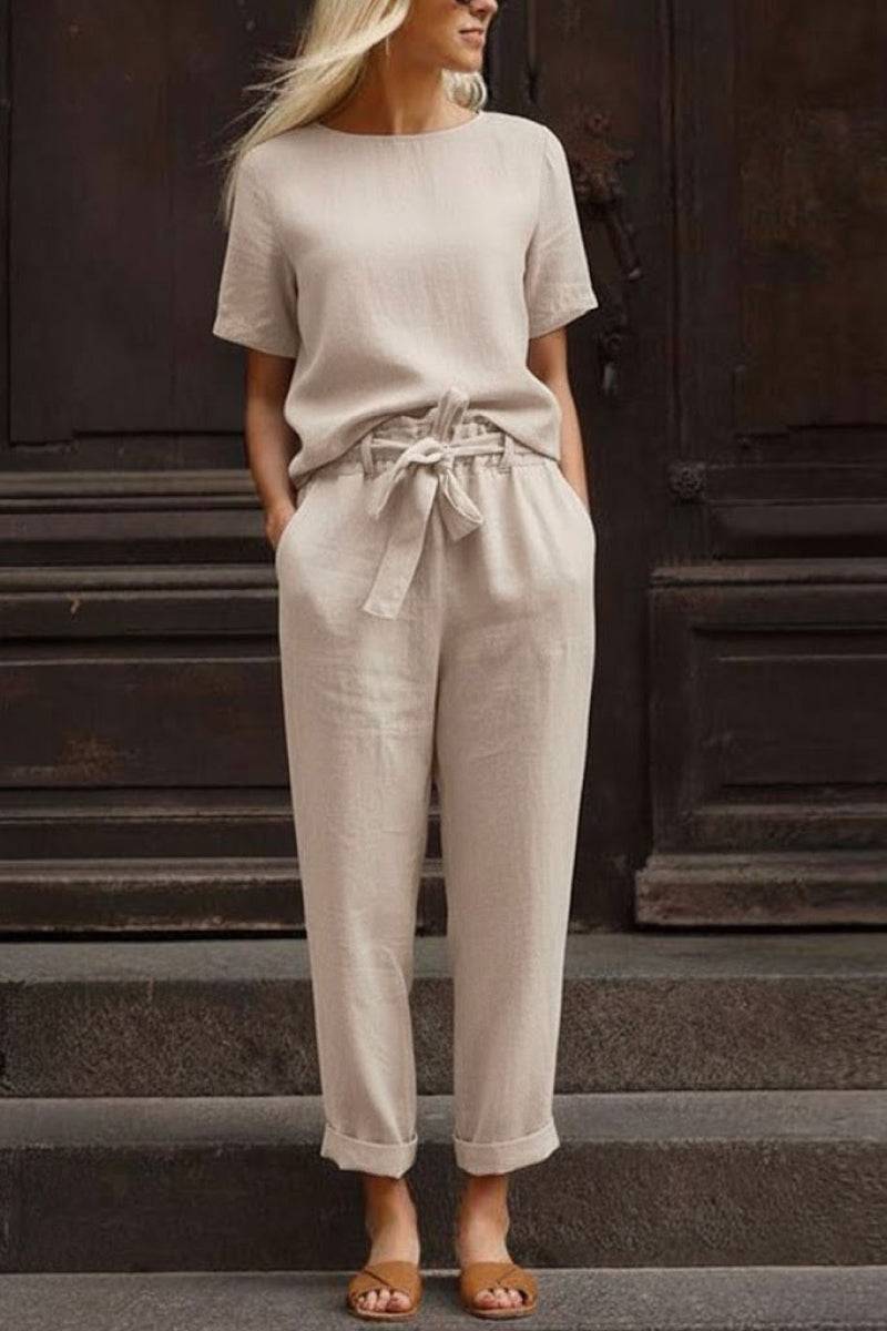 Woman wearing beige cotton linen set with short-sleeve top and straight-leg pants with drawstring waist