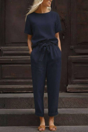 Woman wearing navy blue relaxed cotton linen set with short-sleeve top and drawstring pants
