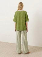 Woman wearing striped wide-leg co-ord set with oversized top and palazzo pants