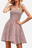 Bohemian skater dress with polka dot pattern, sling knot straps, and elastic top for a comfortable summer fit