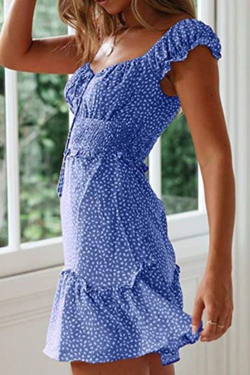 Woman wearing a blue sweetheart collar printed ruffled maxi dress with white floral pattern and ruffle sleeves