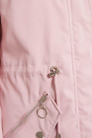 Close-up of pink thick long-sleeve zipper overcoat with metal zipper and adjustable drawstring detail