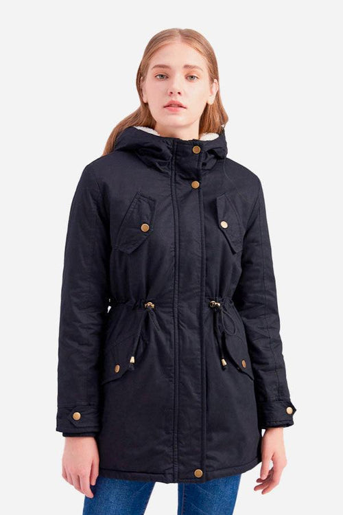 Woman wearing extra comfortable cotton parka coat with hood and button details in black