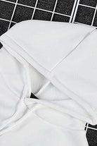 White oversized graffiti rose hoodie with cozy loose fit and long sleeves on grid background