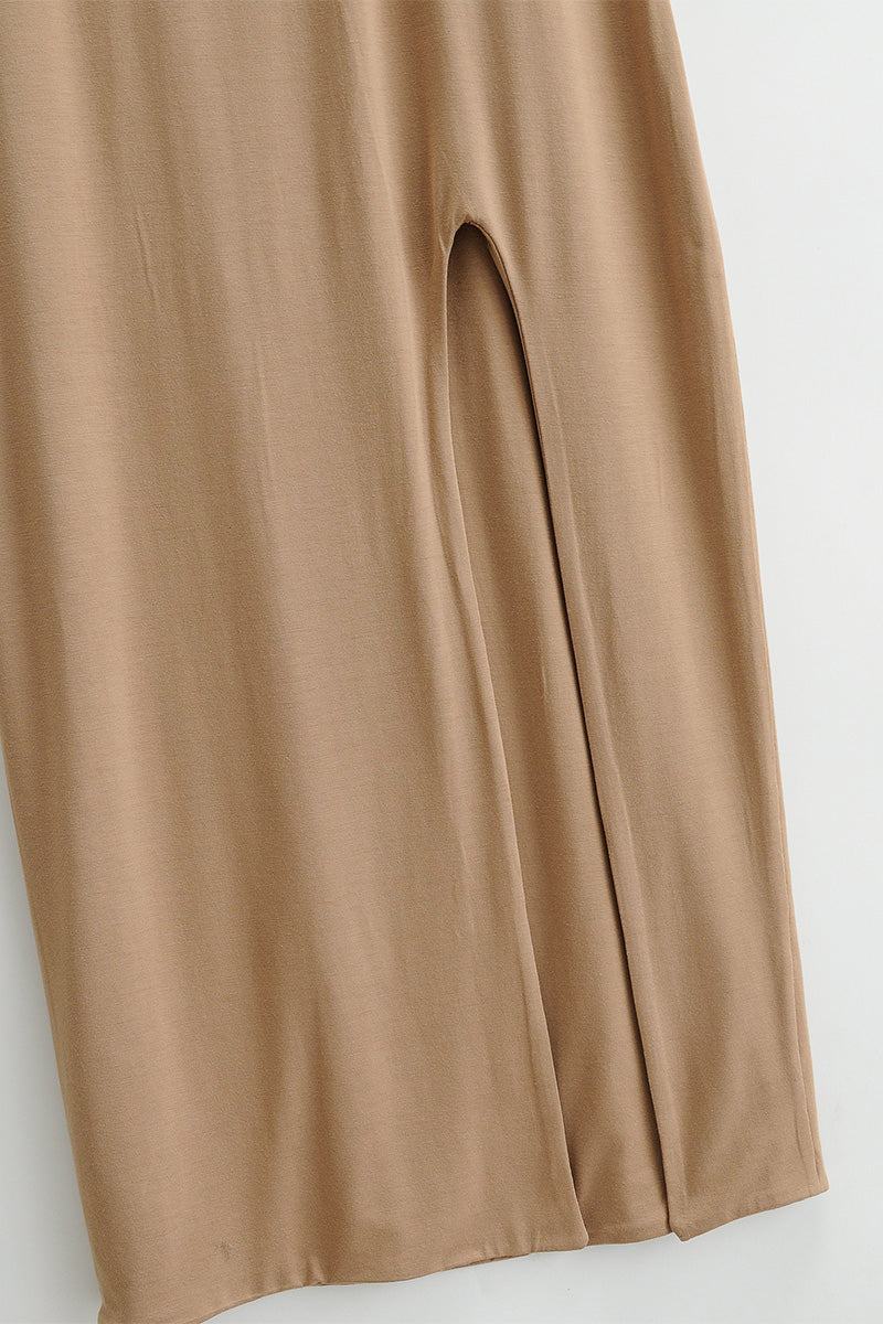 Close-up of beige elegant side slit midi dress fabric and slit detail