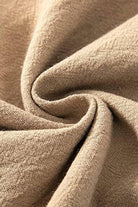 Close-up of beige high-waist cotton linen fabric texture for palazzo pants