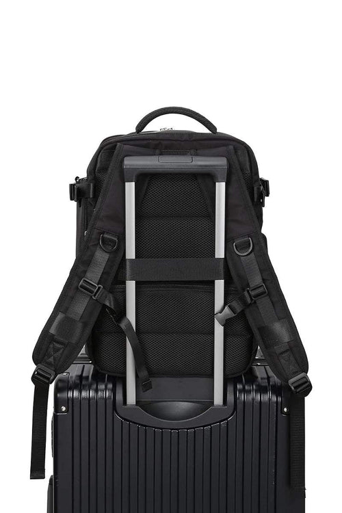 Chic Wanderlust Waterproof Backpack attached to suitcase handle, black ergonomic travel bag with padded straps and durable fabric