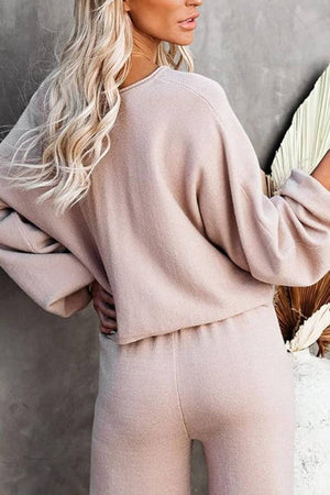Woman wearing beige round neck loose fit cozy two-piece set with long sleeves and wide-leg pants