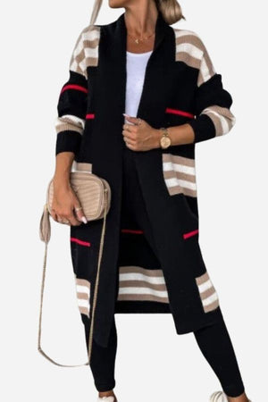 Woman wearing cozy striped long knitted cardigan with oversized fit and long silhouette in black, beige, and red stripes