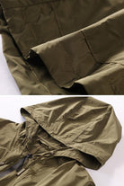 olive green travel ready outdoor raincoat windbreaker with hood and zipper close-up