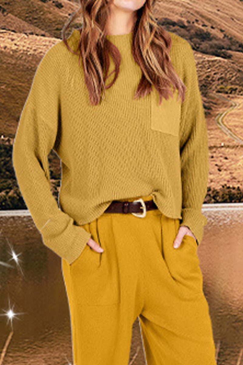 Woman wearing European minimalism relaxed sweater top and trouser set in khaki color outdoors